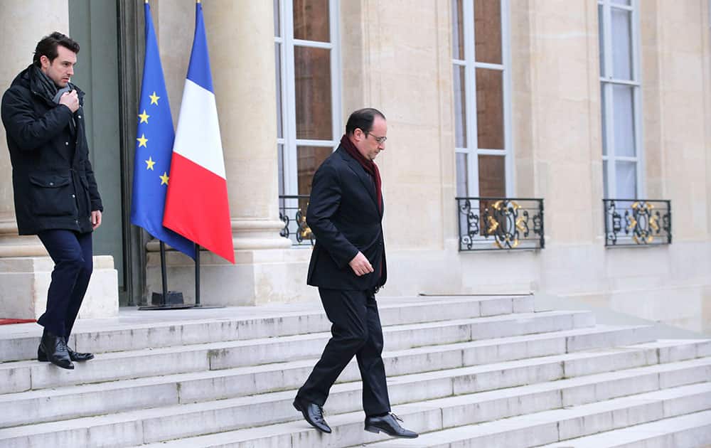 French President Francois Hollande leaves the Elysee Palace after a shooting at a French satirical newspaper, in Paris.