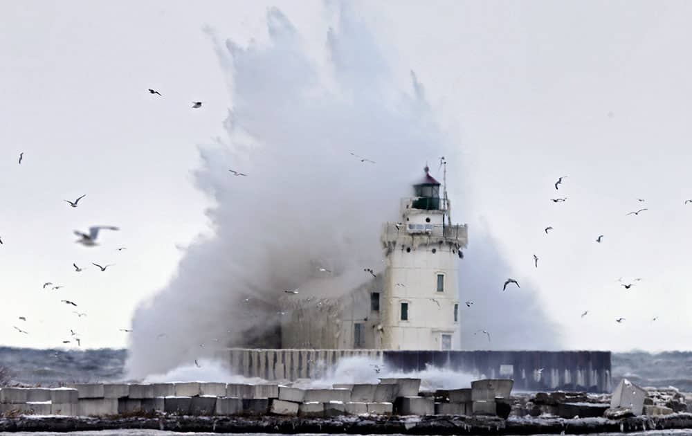 A large wave off Lake Erie engulfs the lighthouse at the entrance to Cleveland harbor.  A blast of arctic air is expected to stick around Ohio a few more days into at least the early part of the weekend and wind chills, already reported below zero in some areas, could dip as low as minus 25 degrees. 