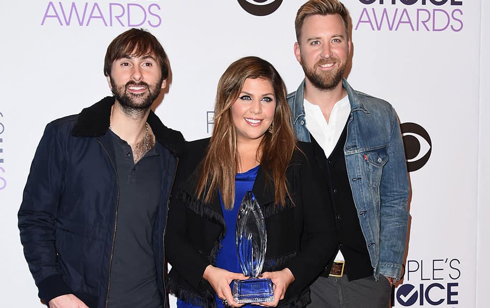 Dave Haywood, from left, Hillary Scott and Charles Kelley of Lady Antebellum pose in the press room with the award for favorite country group at the People's Choice Awards at the Nokia Theatre