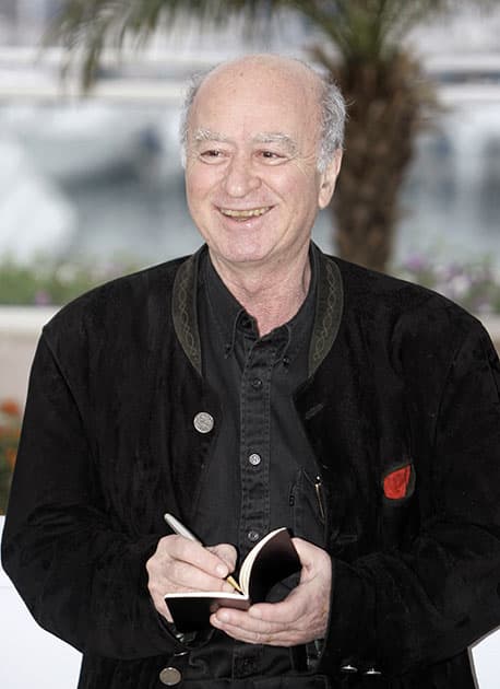 FILE PHOTO, French cartoonist Georges Wolinski draws one of his cartoons at the photo call for the documentary film 'C'est Dur d'Etre Aime Par Des Cons,' during the 61st International film festival in Cannes, southern France. 