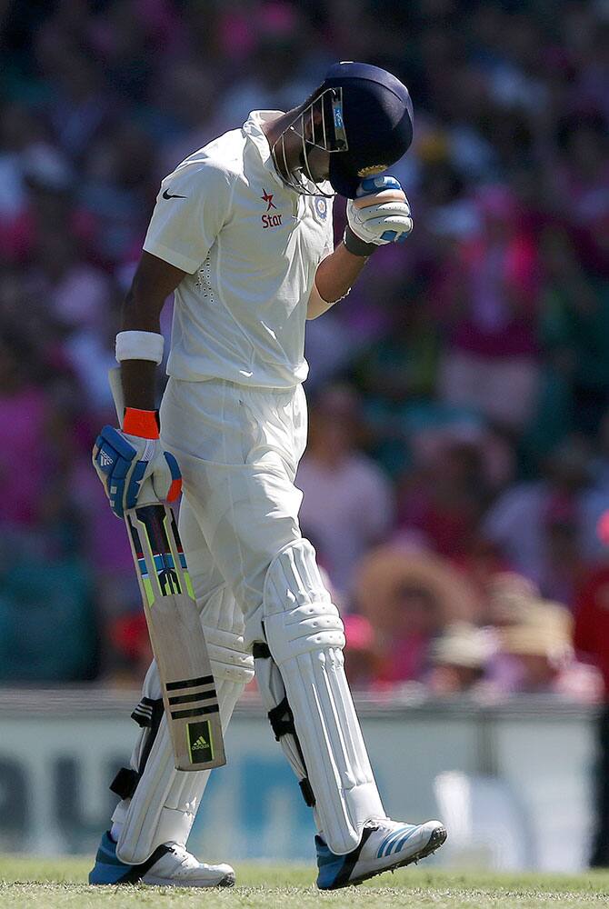 India's Lokesh Rahul walks off with his head down after he was caught out for 110 runs against Australia on the third day of their cricket test match in Sydney.