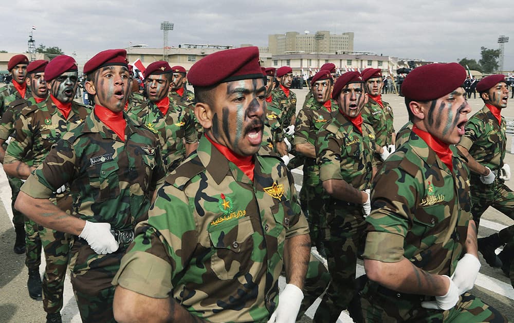 Iraqs police commando unit march during a ceremony marking Police Day at the police academy in Baghdad, Iraq.