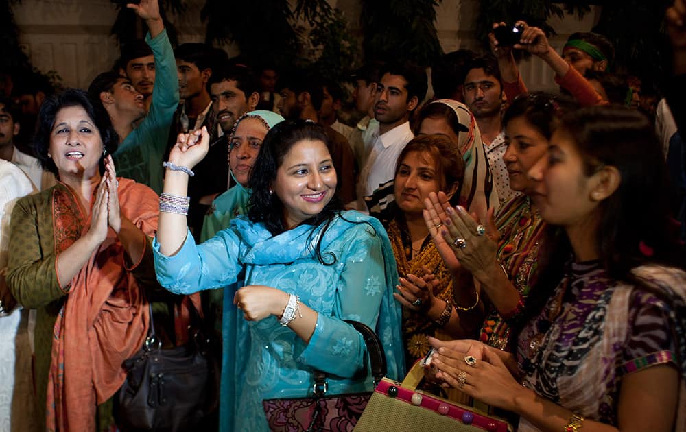 Supporters of Pakistan's cricketer-turned-politician Imran Khan celebrate the marriage of their leader in Karachi, Pakistan.