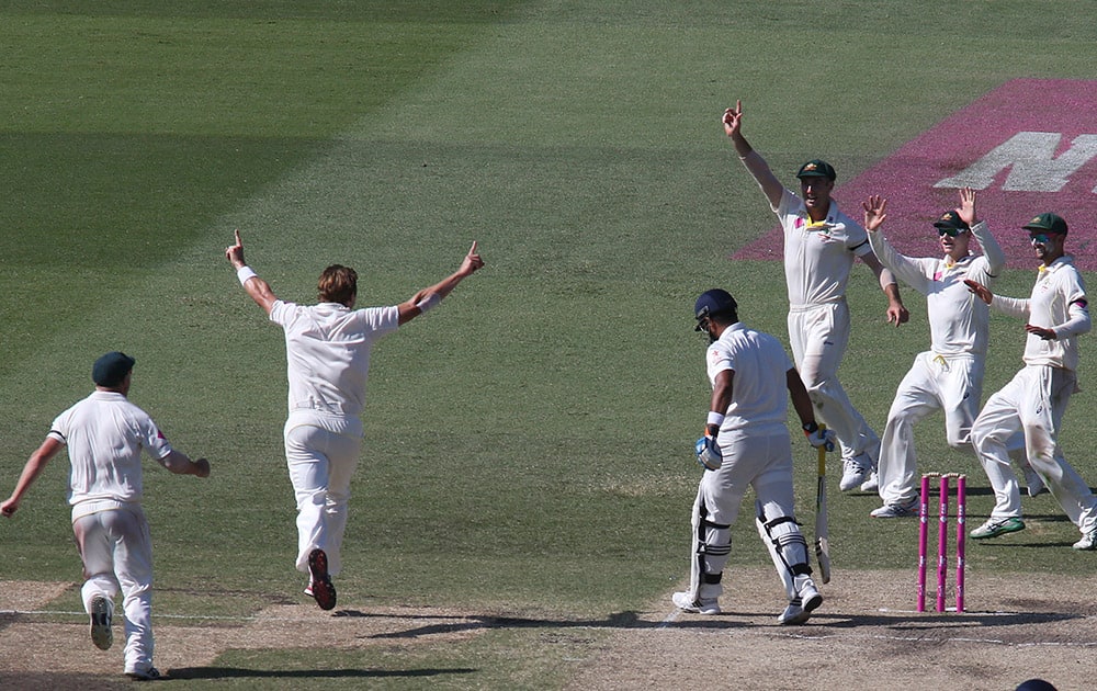 Australian teammates celebrate the wicket of India's Suresh Raina, third left, for no score on the third day of their cricket test match in Sydney.