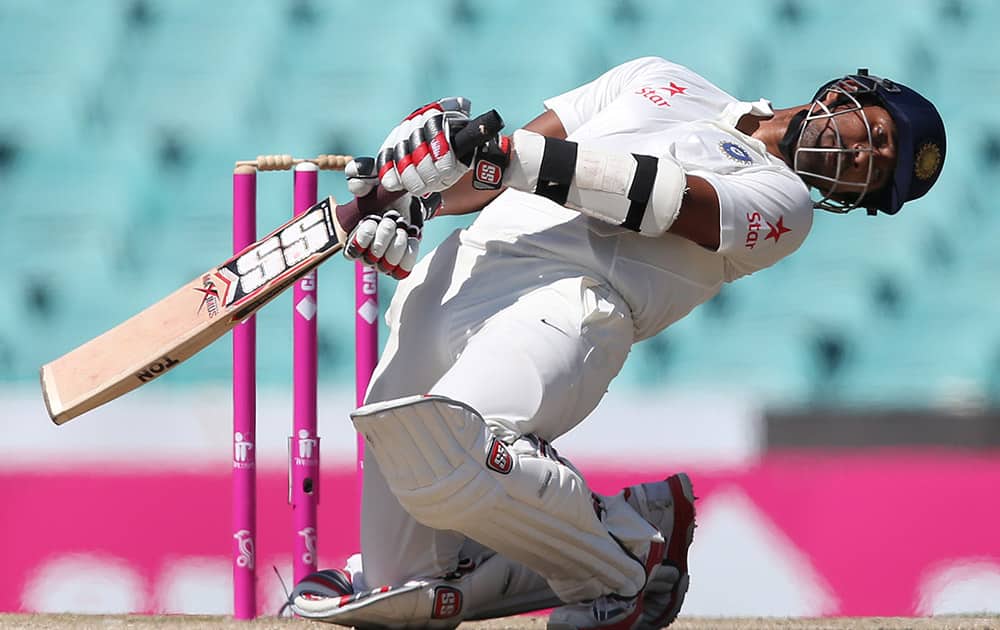 Wriddhiman Saha ducks to avoid a bouncer from Australia's Mitchell Starc on the fourth day of their cricket test match in Sydney.