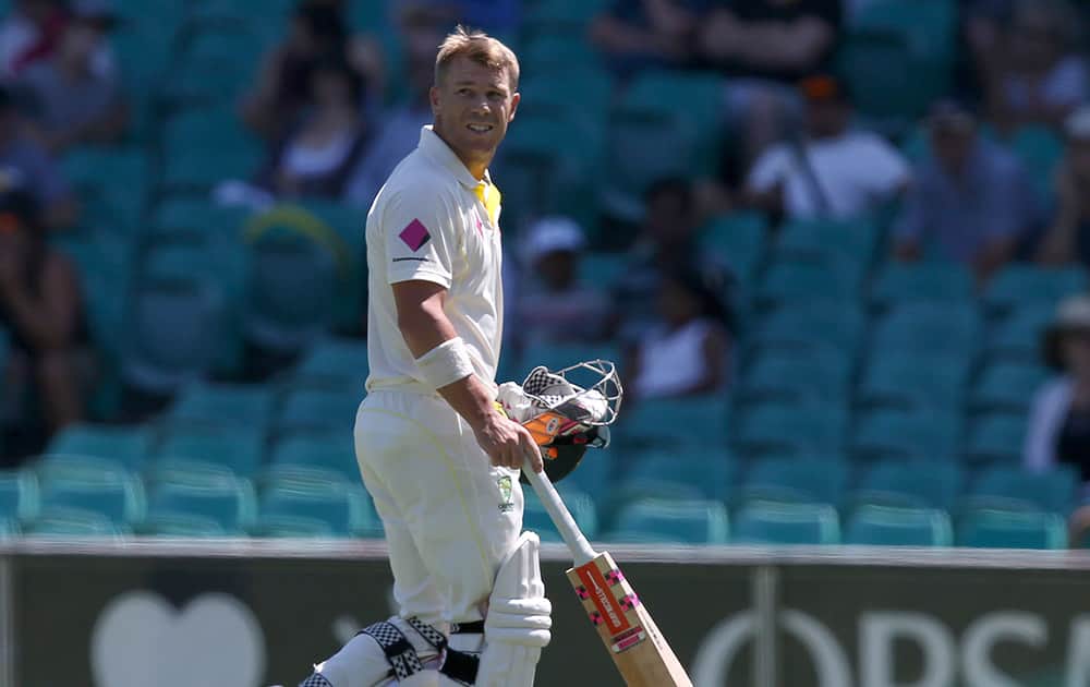 Australia's David Warner walks off after he was caught out for 4 runs against India on the fourth day of their cricket test match in Sydney.