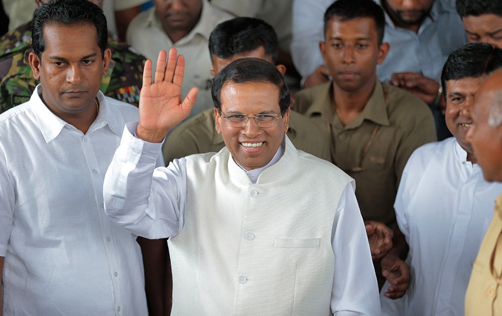 Sri Lanka incoming President Maithripala Sirisena waves to supporters as he leaves the election secretariat in Colombo, Sri Lanka. In a stunning election result that was unthinkable just weeks ago, Sri Lanka's longtime president acknowledged Friday that he had been defeated by a onetime political ally, signaling the fall of a family dynasty and the rise of former Cabinet minister Sirisena.