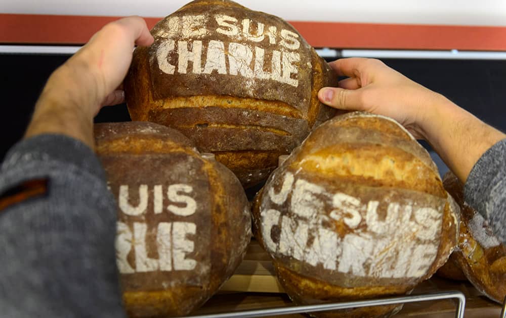 Baker Pascal Clement arranges loafs of bread with 
