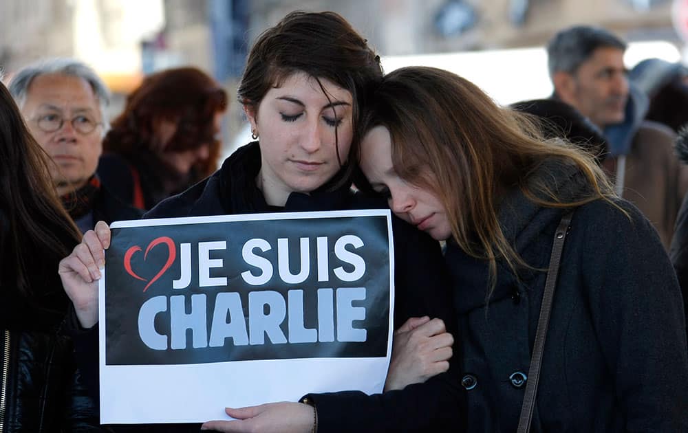People pay tribute to the victims of the satirical newspaper 'Charlie Hebdo', in Marseille, southern France.