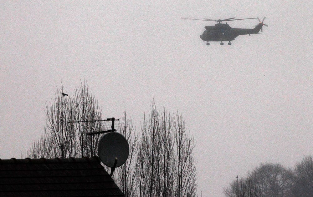 Police helicopter circles over Dammartin-en-Goele, northeast Paris, as part of an operation to seize two heavily armed suspects.