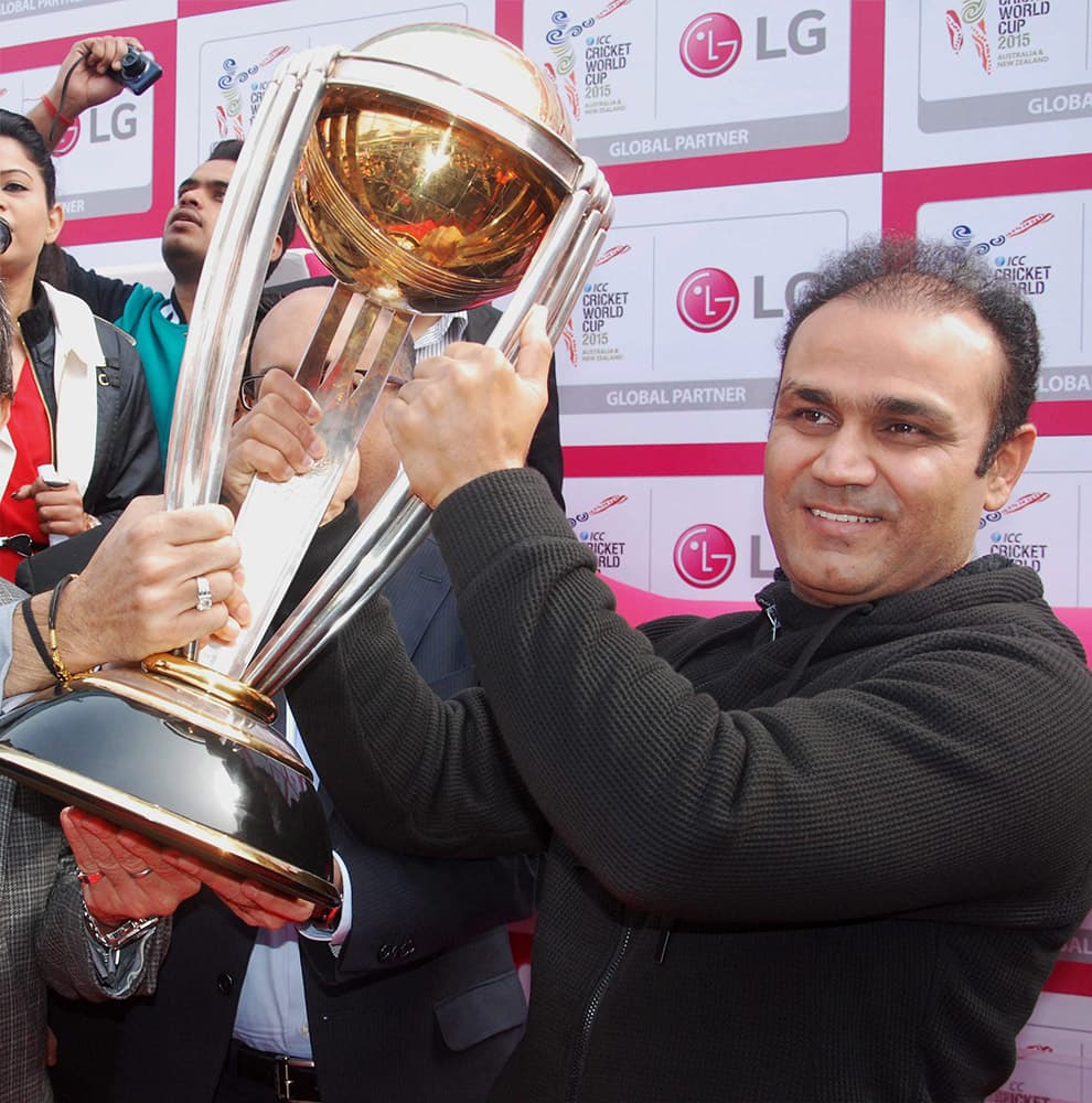 Virender Sehwag displays the ICC World Cup 2015 trophy at an event in Gurgaon.