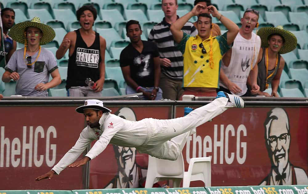 Rohit Sharma dives in an attempt to field the ball against Australia on the fourth day of their cricket test match in Sydney.