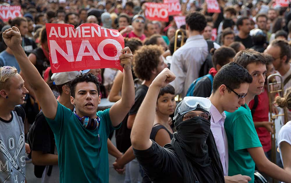 Demonstrators holding signs that read in Portuguese 'No Rise,' protest against a rise of public transportation fares in Sao Paulo, Brazil.