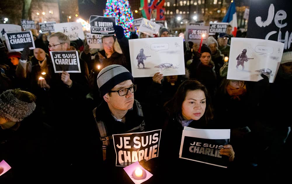 People gather to pay to pay tribute to victims of the terrorist attack against the French satirical weekly Charlie Hebdo.