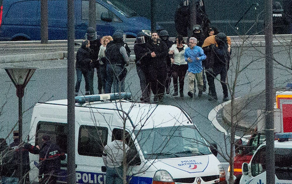 Security officers escort released hostages after they stormed a kosher market to end a hostage situation, Paris.