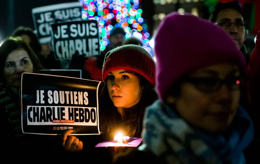 People gather to pay to pay tribute to victims of the terrorist attack against the French satirical weekly Charlie Hebdo, at JFK Plaza, commonly known as Love Park, in Philadelphia.