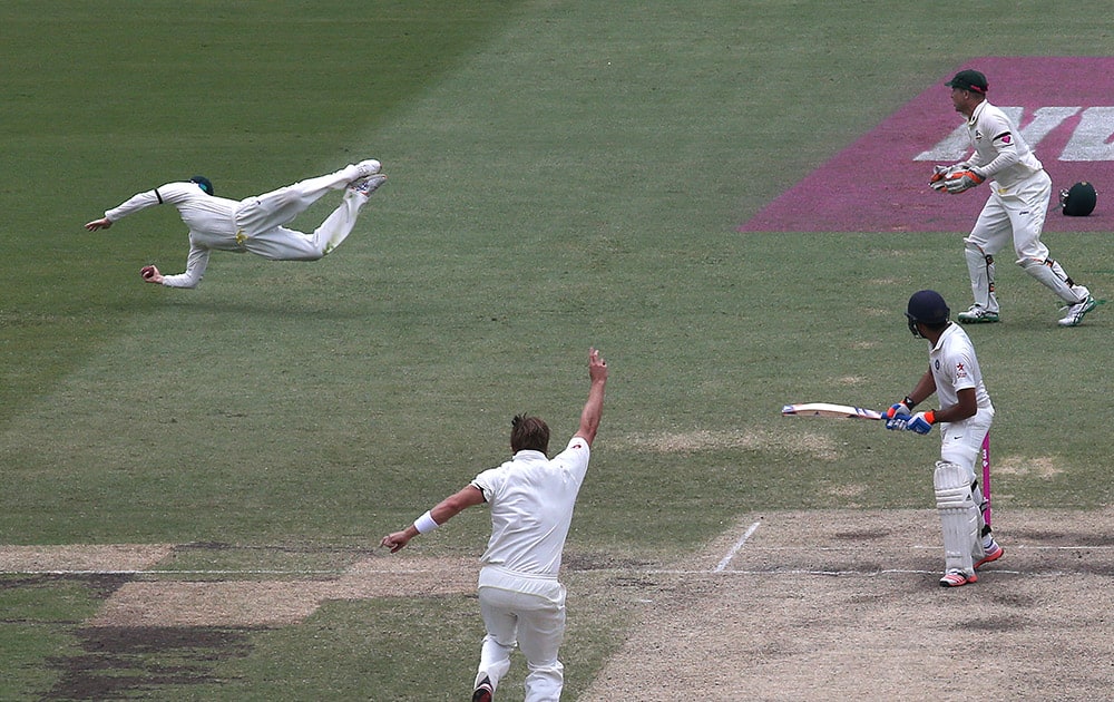 Australia's Steve Smith, dives to catch out India's Rohit Sharma, for 39 runs on the fifth day of their cricket test match in Sydney.