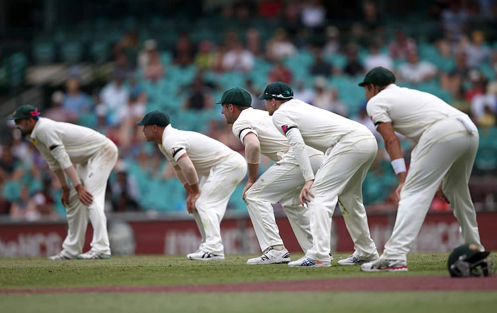 Australian players Nathan Lyon, David Warner, Shaun Marsh, Steve Smith, and Shane Watson, line up in the slips to field against India on the fifth day of their cricket test match in Sydney.