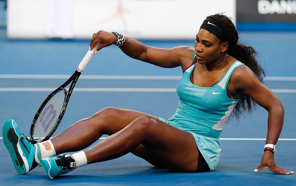 Serena Williams of the U.S falls onto the court after missing a shot against Agnieszka Radwanska of Poland during the women's singles final at the Hopman Cup tennis tournament in Perth, Australia.
