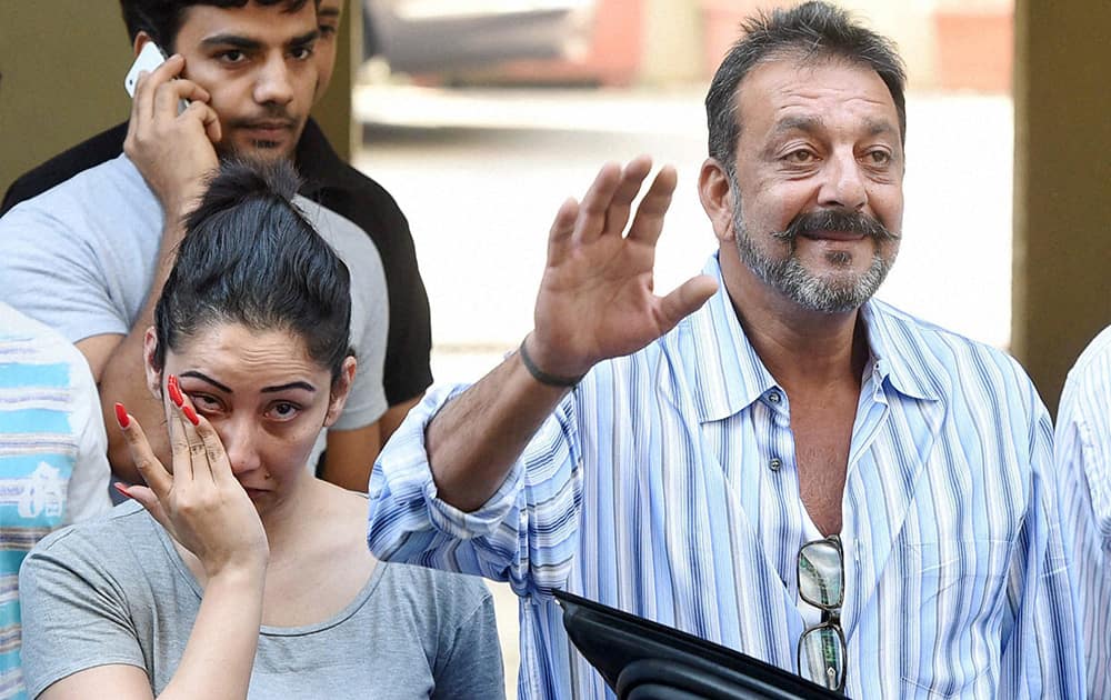 Sanjay Dutt with his wife Manyata as he leaves his residence to return to jail after the Yerwada Prison authorities rejected his plea for the extension of his furlough, in Mumbai.