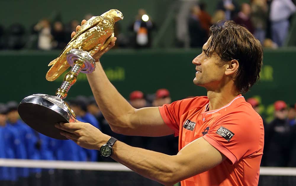 Spain's David Ferrer poses with his trophy after winning the Qatar's ExxonMobil Open in Doha, Qatar.