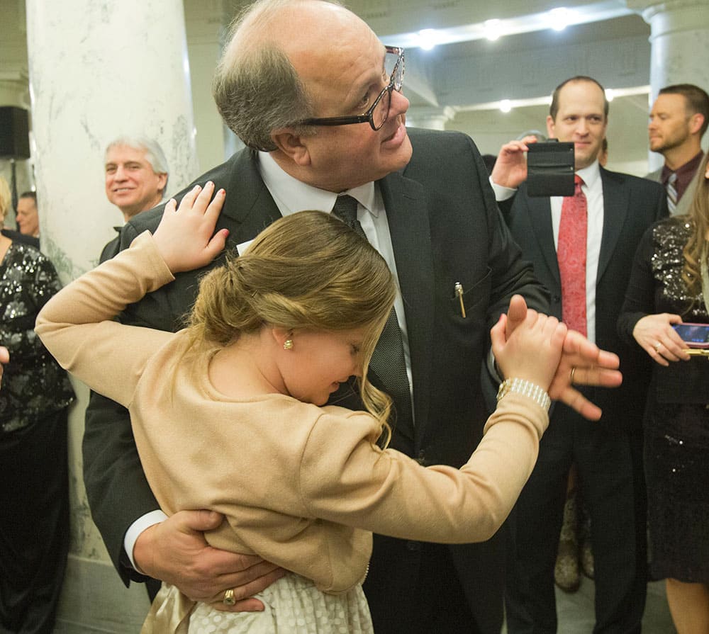 Sen. Bart Davis and one of his granddaughters, Brooklyn Davis, 11, takes to the dance floor at the Inaugural Ball at the Idaho State Capitol.
