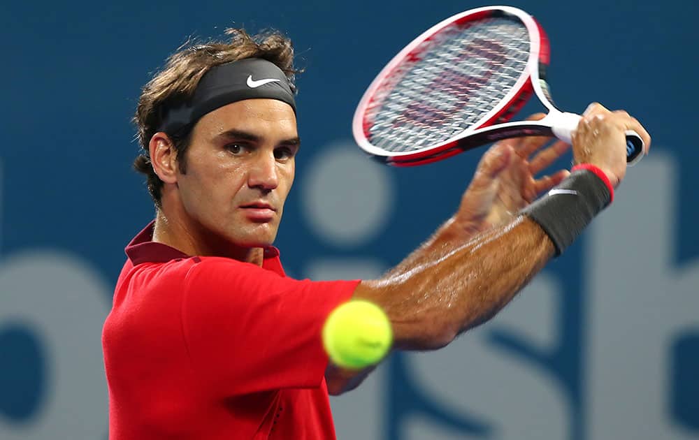 Roger Federer of Switzerland plays a shot in the men's final match against Milos Raonic of Canada during the Brisbane International tennis tournament.