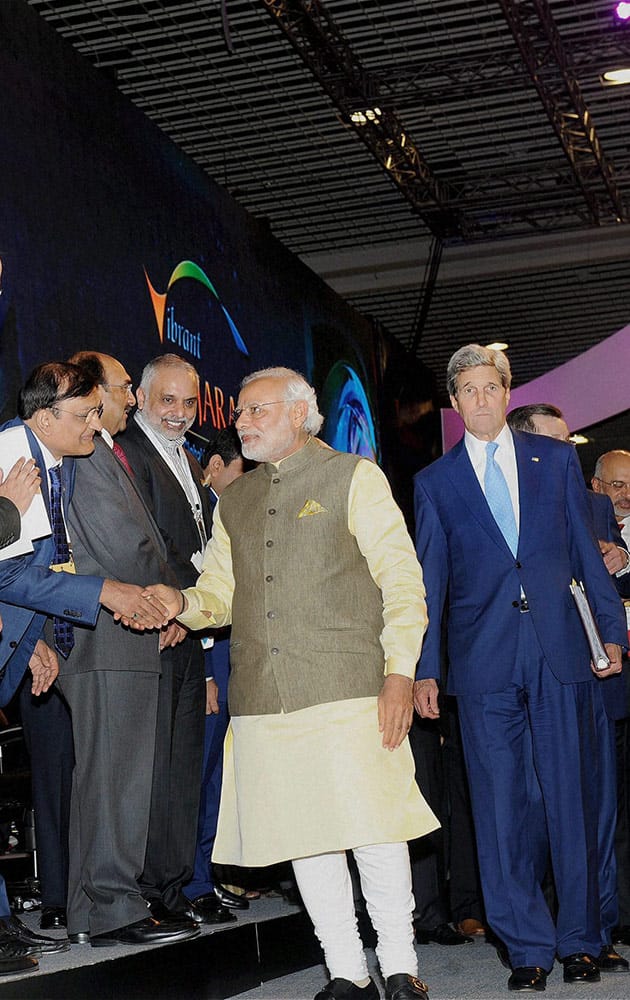 Prime Minister Narendra Modi meeting delegates as US Secretary of State, John Kerry looks on at Vibrant Gujarat Global Summit 2015 in Gandhinagar.