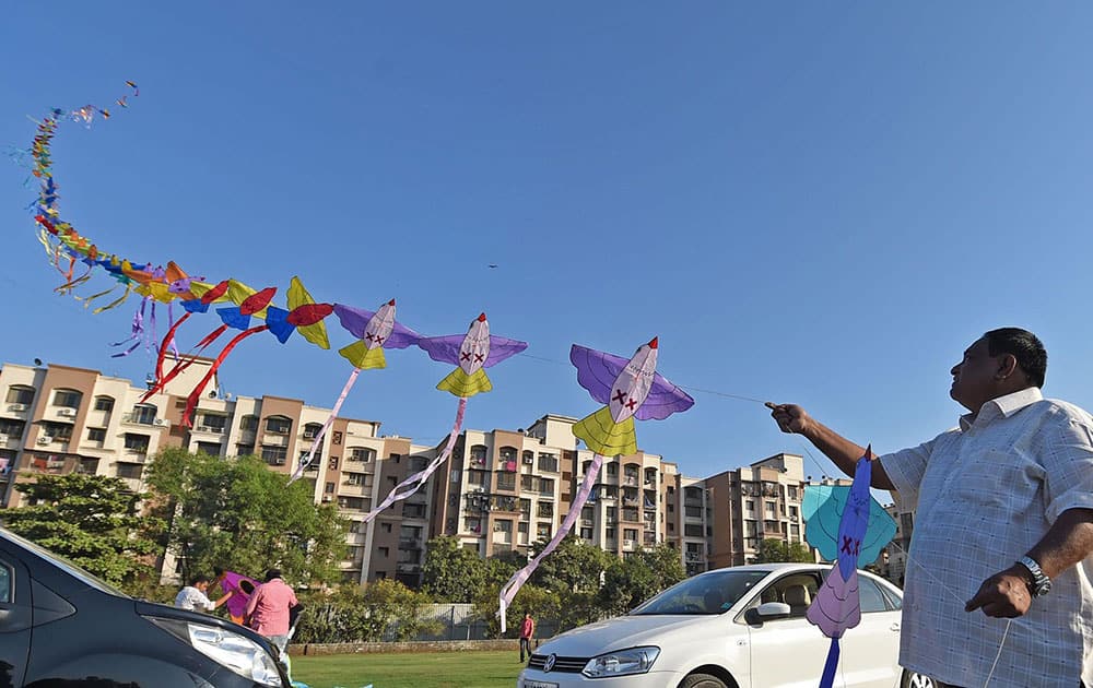 A man flies 150 kites during a Kite festival in Mumbai.