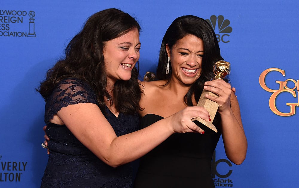 Evelise Rodriguez and Gina Rodriguez pose in the press room with the award for best actress in a television series - musical or comedy for “Jane the Virgin” at the 72nd annual Golden Globe Awards at the Beverly Hilton Hotel, in Beverly Hills, Calif. 