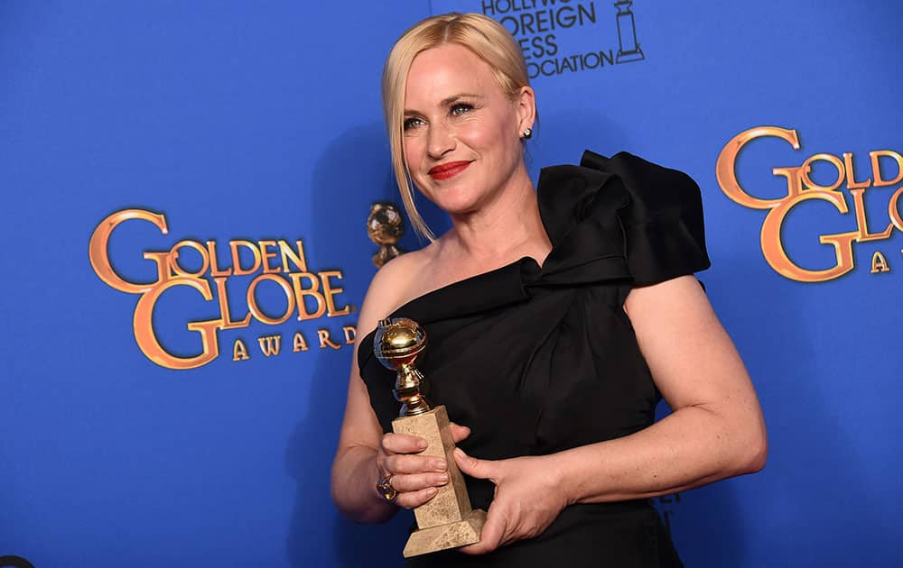 Patricia Arquette poses in the press room with the award for best supporting actress in a motion picture for 