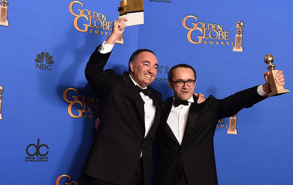 Alexander Rodnyansky, left, and Andrey Zvyagintsev pose in the press room with the award for best foreign film for 