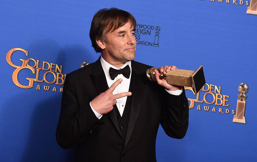 Richard Linklater poses in the press room with the award for best director for 