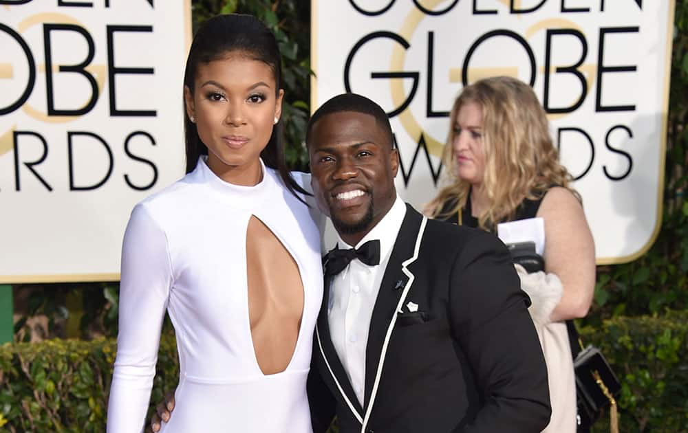 Eniko Parrish, left, and Kevin Hart arrive at the 72nd annual Golden Globe Awards.