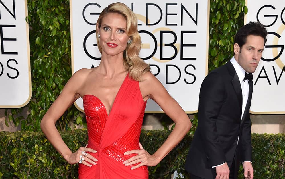 Paul Rudd, right, looks on as Heidi Klum poses at the 72nd annual Golden Globe Awards.