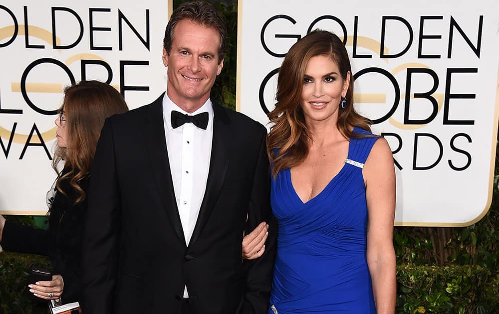 Rande Gerber, left and Cindy Crawford arrive at the 72nd annual Golden Globe Awards.