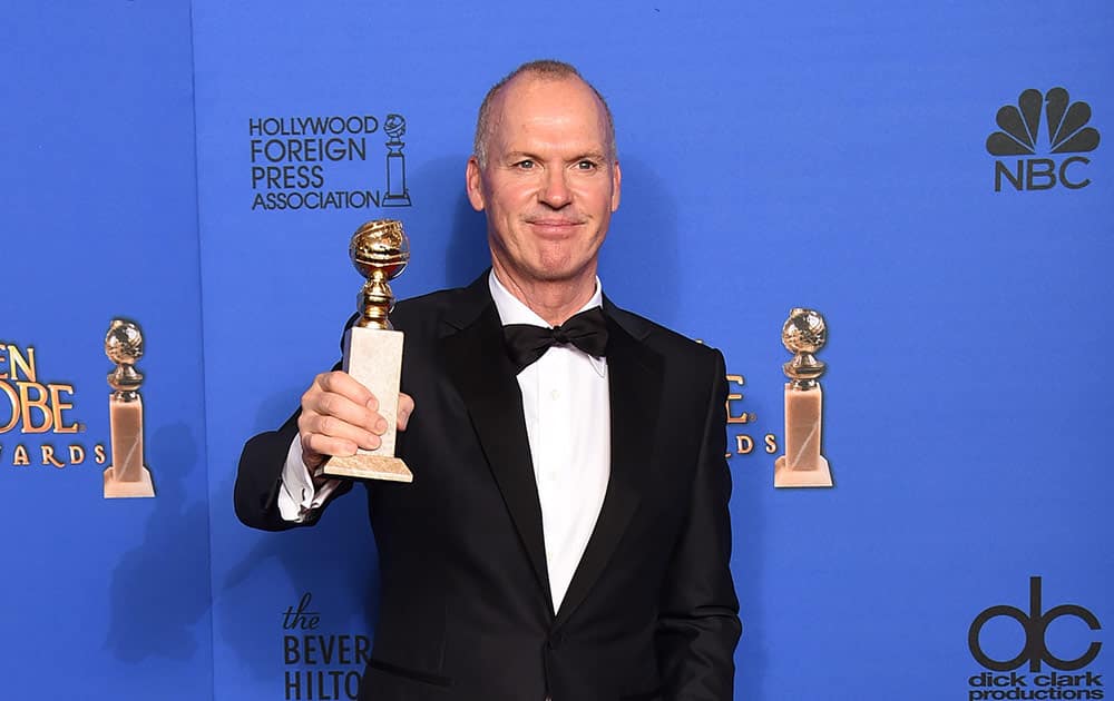 Michael Keaton poses in the press room with the award for best actor in a motion picture - musical or comedy for “Birdman” at the 72nd annual Golden Globe Awards.