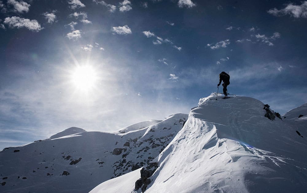 A backcountry skiier climbs up towards the Mederger Flue peak (2706 meters above sea level),in Davos, Switzerland. 