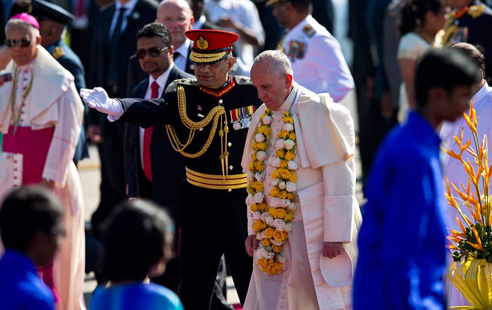 Chief of defence staff Gen. Jagath Jayasuriya leads Pope Francis at the airport in Colombo, Sri Lanka.