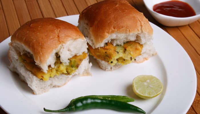 Indian street food is as delicious as India’s mainstream cuisine. Each city in the country has its unique food preferences and that reflects in the kind of food that is popular among the dwellers.
In this slideshow, we will take a look at India’s financial capital- Mumbai’s TOP 10 food items:
Vada Pav:
If you are in Mumbai, and if you haven’t eaten Vada Pav, then you are no foodie. Vada Pavs are a must for people who love to gorge on food. Vadas are made of mashed boiled potatoes that are dipped in gramflour batter and fried until golden brown. Vadas are then sandwiched between two halves of a pav and served along with chopped onions and green chillies.
(Pic courtesy: Thinkstock Photos)