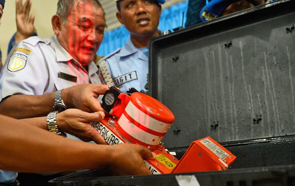 Head of Indonesian National Transportation Safety Committee Tatang Kurniadi, shows, the newly recovered Cockpit Voice Recorder from the ill-fated AirAsia Flight 8501 during a press conference in Pangkalan Bun, Central Borneo, Indonesia.