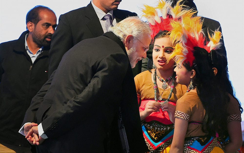 Prime Minister Narendra Modi sharing a word with students during Sankranti Milan hosted by Union Urban Development Minister M Venkaiah Naidu at his residence in New Delhi.