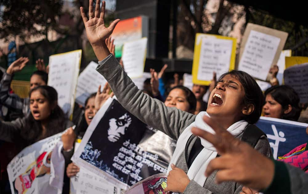 A woman shouts slogans during a protest outside police headquarters against alleged police negligence in the murder and suspected rape of a woman in New Delhi, India.