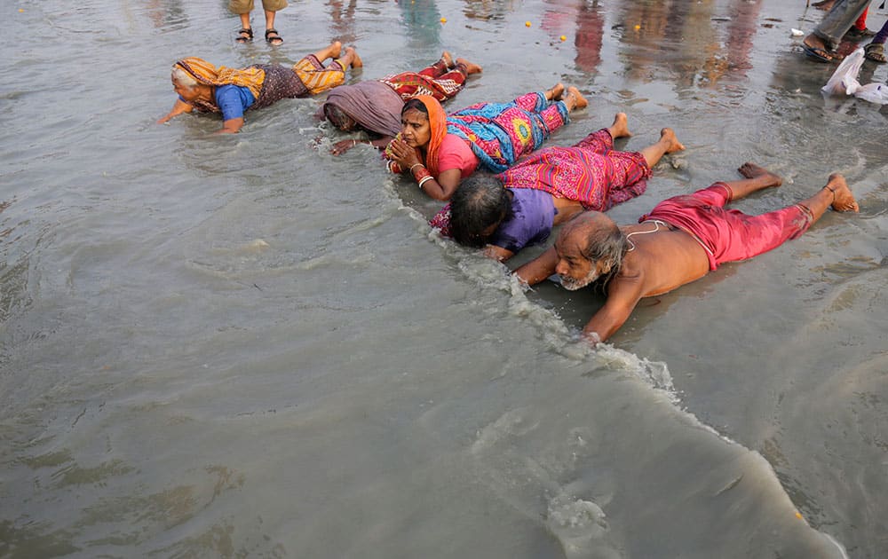 Hindu pilgrims offer prayers prior to taking a holy dip in Gangasagar.