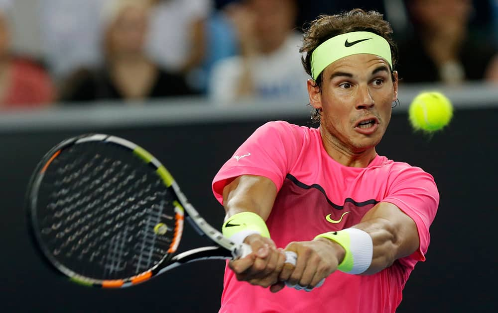 Spain's Rafael Nadal plays a backhand return to Australia's Mark Philippoussis during an exhibition match on Margaret Court Arena ahead of the Australian Open tennis championship in Melbourne, Australia.