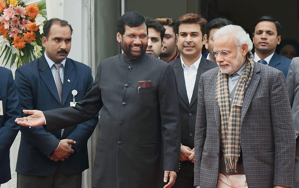 Union minister and LJP leader Ram Vilas Paswan welcomes Prime Minister Narendra Modi at an event organised by him to celebrate Makar Sankranti festival, at his residence in New Delhi.