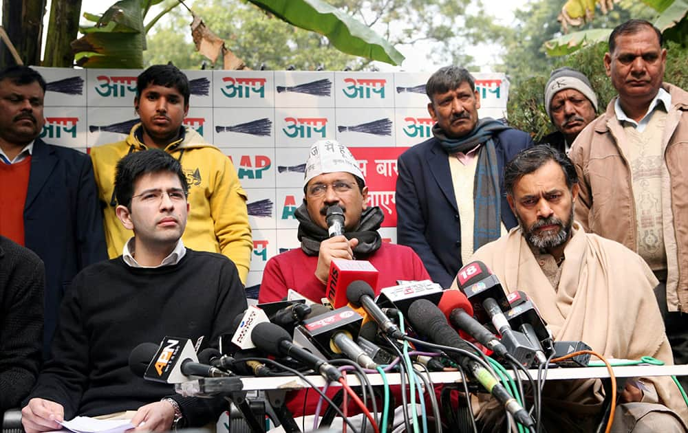 AAP chief Arvind Kejriwal addresses a press conference with AAP leader Yogendra Yadav in New Delhi.