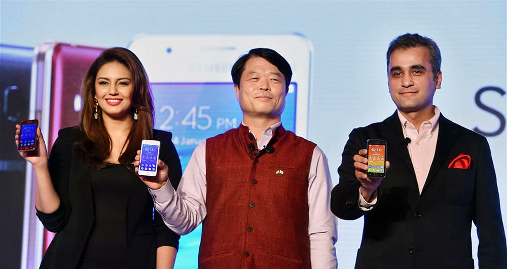 President and CEO of Samsung India Electronics Hyun Chil Hong, with Vice President Asim Warsi and Bollywood actress Huma Qureshi pose for photos during the launch of Sumsung Z1 in New Delhi.