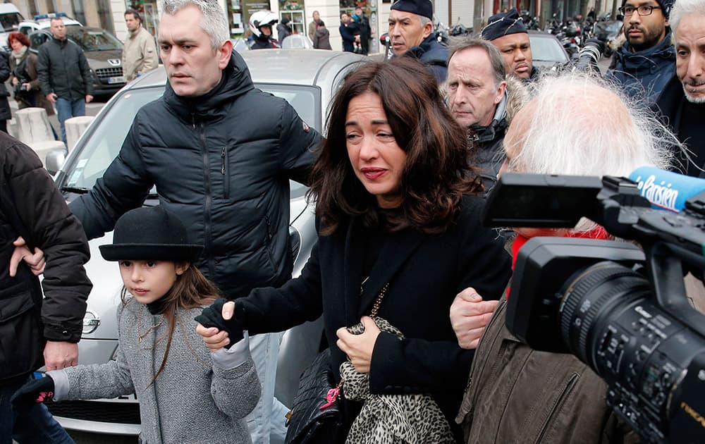 Daughter of French cartoonist Georges Wolinski, Elsa Wolinski, arrives at the funeral of her father at the Pere Lachaise cemetery, in Paris.