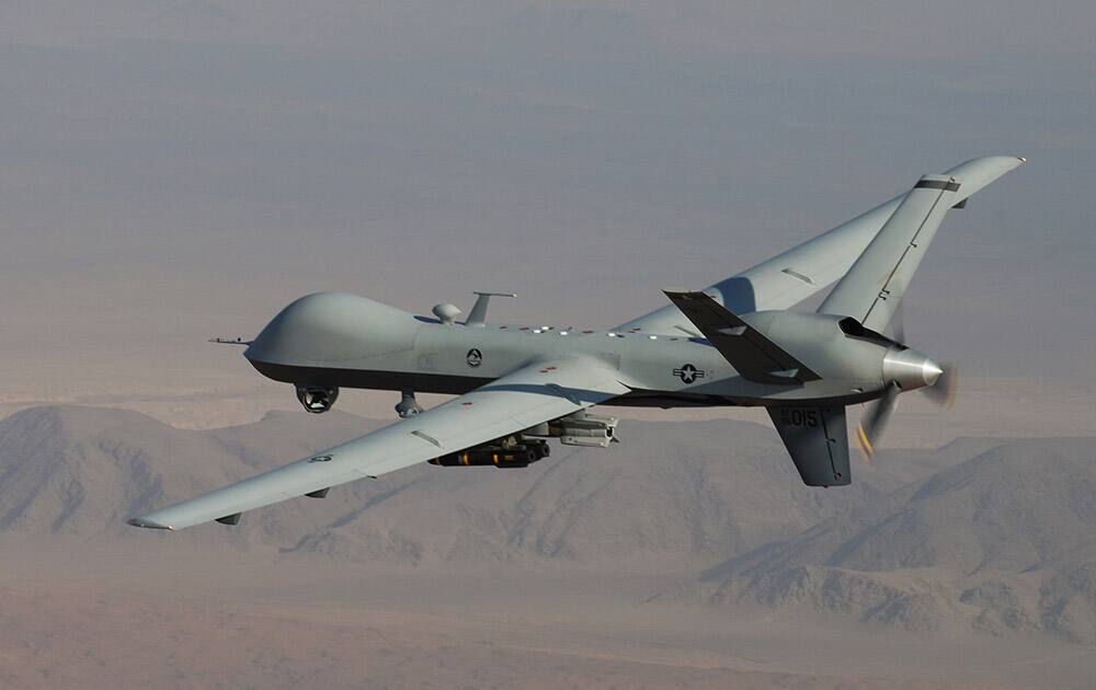 This undated handout file photo provided by the US Air Force, a MQ-9 Reaper, armed with GBU-12 Paveway II laser guided munitions and AGM-114 Hellfire missiles, is piloted by Col. Lex Turner during a combat mission over southern Afghanistan.